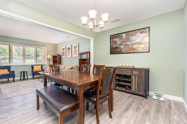 139 Hollyhock Ct, Durham, NC 27713 - dining room with light wood-type flooring, baseboards, and a chandelier