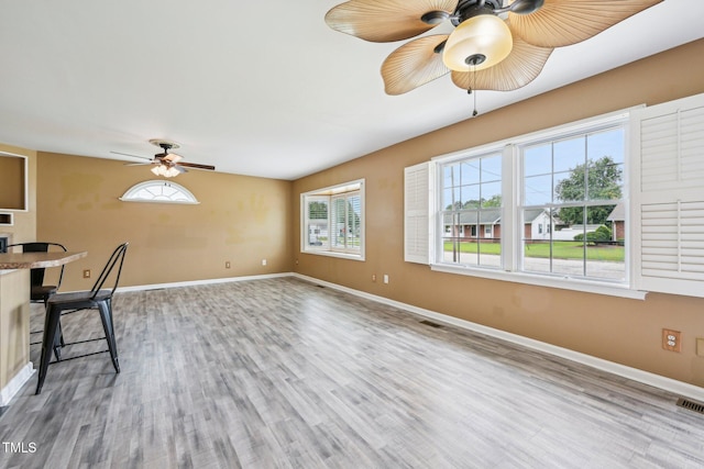 102 Pine St, Dunn, NC 28334 - unfurnished living room with a ceiling fan, wood finished floors, and baseboards