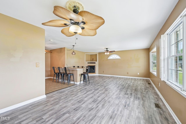 102 Pine St, Dunn, NC 28334 - living area featuring wood finished floors, a ceiling fan, baseboards, and a fireplace