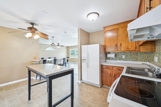 102 Pine St, Dunn, NC 28334 - kitchen featuring white appliances, range hood, a ceiling fan, a sink, and brown cabinets