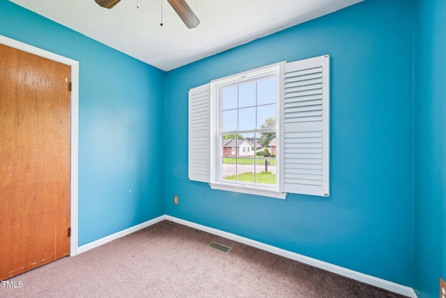 102 Pine St, Dunn, NC 28334 - carpeted spare room featuring a ceiling fan, baseboards, and a textured ceiling