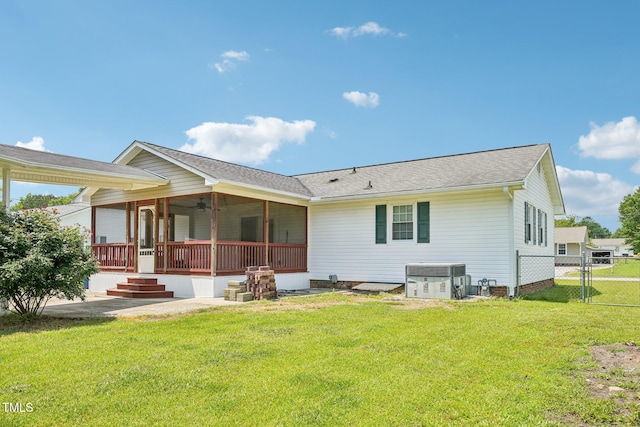 102 Pine St, Dunn, NC 28334 - back of property featuring cooling unit, a ceiling fan, roof with shingles, and a gate