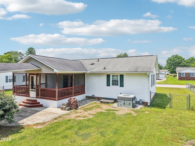 102 Pine St, Dunn, NC 28334 - back of property with a gate, cooling unit, a patio, and roof with shingles