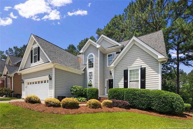 15 London Way, Spring Lake, NC 28390 - traditional-style home with roof with shingles, a front lawn, and a garage