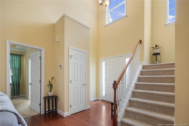 15 London Way, Spring Lake, NC 28390 - foyer featuring wood finished floors, a high ceiling, stairway, and baseboards