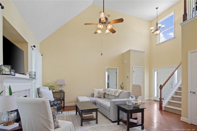 15 London Way, Spring Lake, NC 28390 - living room featuring high vaulted ceiling, wood finished floors, ceiling fan, a fireplace, and baseboards