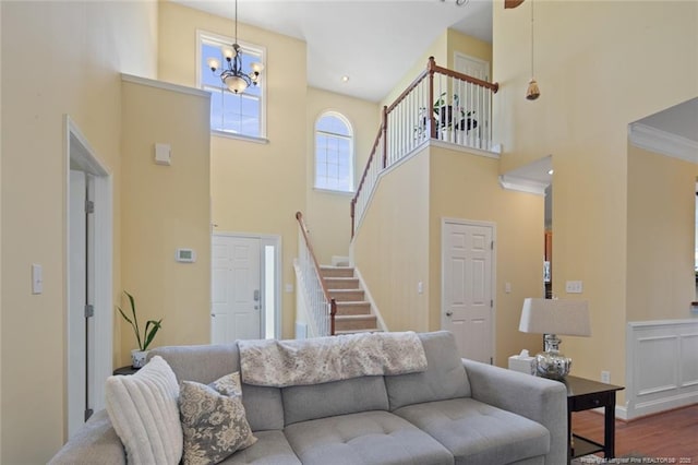 15 London Way, Spring Lake, NC 28390 - living area featuring a high ceiling, stairway, dark wood-style flooring, a chandelier, and baseboards