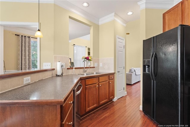 15 London Way, Spring Lake, NC 28390 - kitchen with black refrigerator with ice dispenser, a sink, ornamental molding, dark wood-style floors, and stainless steel dishwasher