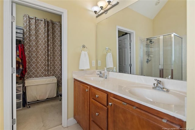 15 London Way, Spring Lake, NC 28390 - bathroom with double vanity, a stall shower, vaulted ceiling, and a walk in closet