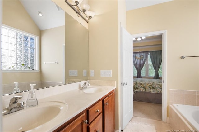 15 London Way, Spring Lake, NC 28390 - ensuite bathroom featuring tiled bath, double vanity, tile patterned floors, and vaulted ceiling