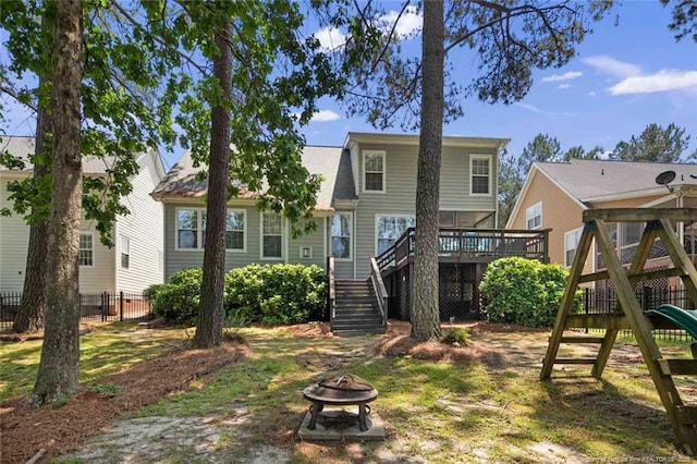 15 London Way, Spring Lake, NC 28390 - back of property featuring an outdoor fire pit, stairway, a wooden deck, and a playground