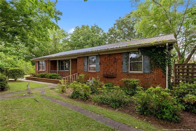 114 Birch Cir, Raeford, NC 28376 - ranch-style home with brick siding, a front yard, and metal roof