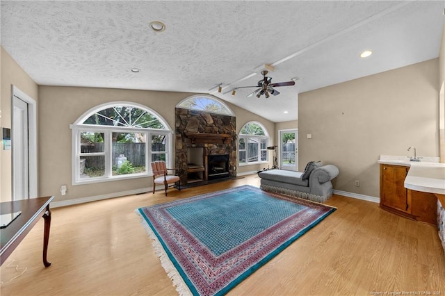 114 Birch Cir, Raeford, NC 28376 - living area with light wood-style flooring, ceiling fan, plenty of natural light, a textured ceiling, and lofted ceiling