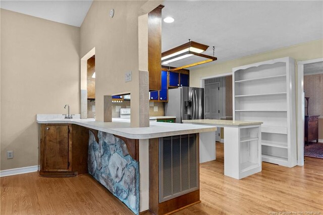 114 Birch Cir, Raeford, NC 28376 - kitchen with open shelves, stainless steel fridge with ice dispenser, light wood-style flooring, and light countertops