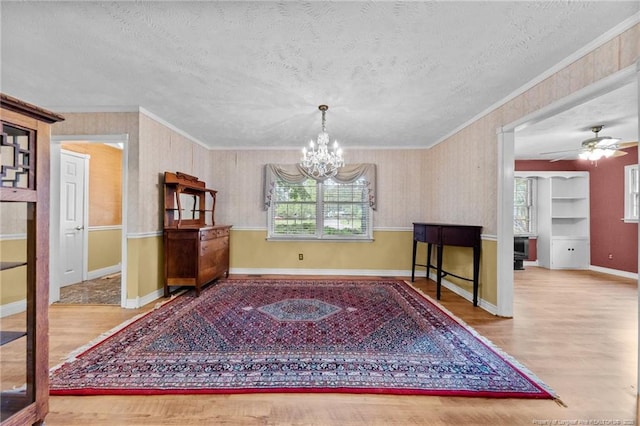 114 Birch Cir, Raeford, NC 28376 - dining space featuring plenty of natural light, a chandelier, wood finished floors, a textured ceiling, and ornamental molding