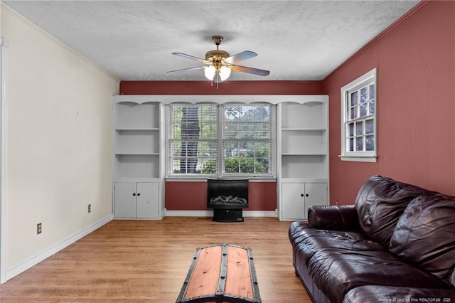 114 Birch Cir, Raeford, NC 28376 - living area featuring ceiling fan, wood finished floors, a textured ceiling, ornamental molding, and baseboards