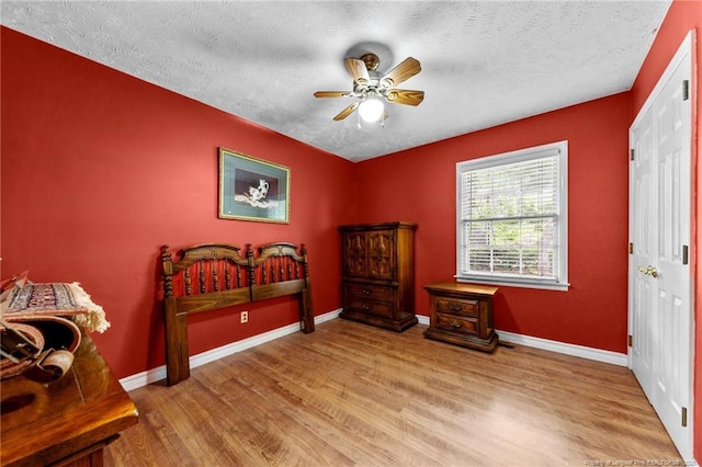 114 Birch Cir, Raeford, NC 28376 - bedroom with wood finished floors, a textured ceiling, baseboards, and ceiling fan