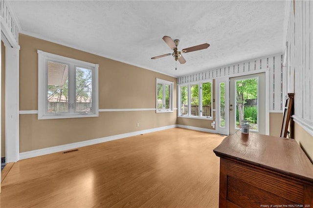 114 Birch Cir, Raeford, NC 28376 - unfurnished living room with a ceiling fan, plenty of natural light, light wood-style flooring, a textured ceiling, and baseboards