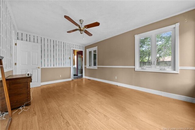 114 Birch Cir, Raeford, NC 28376 - empty room featuring a ceiling fan, wood finished floors, wallpapered walls, and baseboards