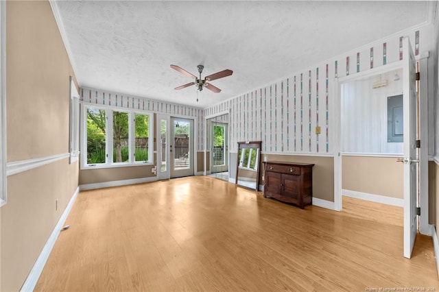 114 Birch Cir, Raeford, NC 28376 - unfurnished living room with ceiling fan, wallpapered walls, baseboards, a textured ceiling, and wood finished floors