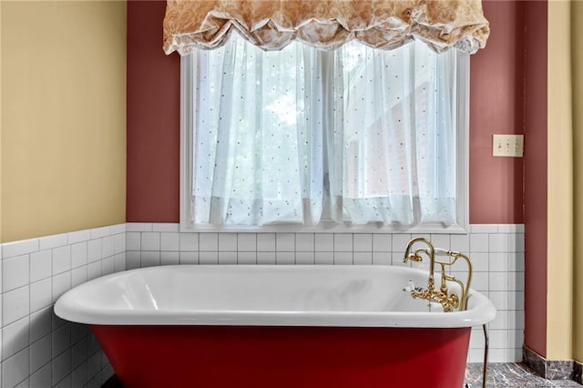 114 Birch Cir, Raeford, NC 28376 - full bath featuring tile walls, healthy amount of natural light, a freestanding bath, and a wainscoted wall