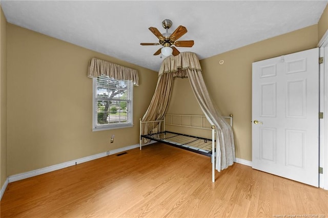 114 Birch Cir, Raeford, NC 28376 - unfurnished bedroom with light wood finished floors, baseboards, and a ceiling fan