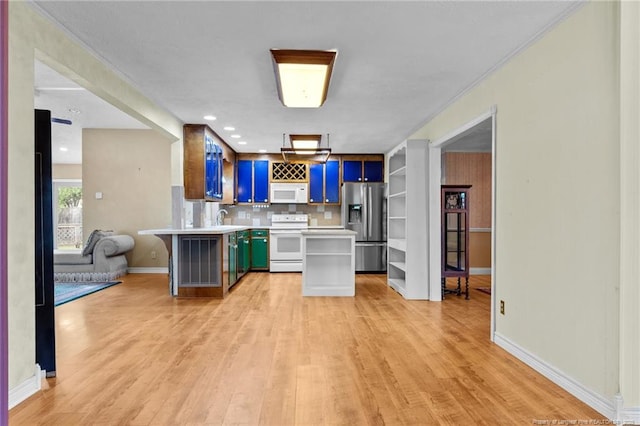 114 Birch Cir, Raeford, NC 28376 - kitchen featuring white appliances, light countertops, light wood finished floors, and a peninsula