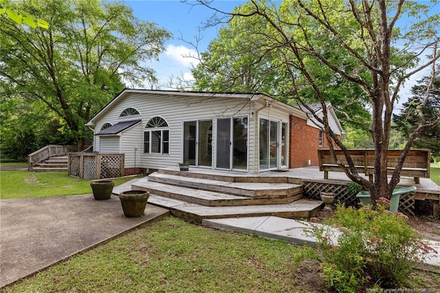 114 Birch Cir, Raeford, NC 28376 - back of house featuring a wooden deck, a patio, and a yard