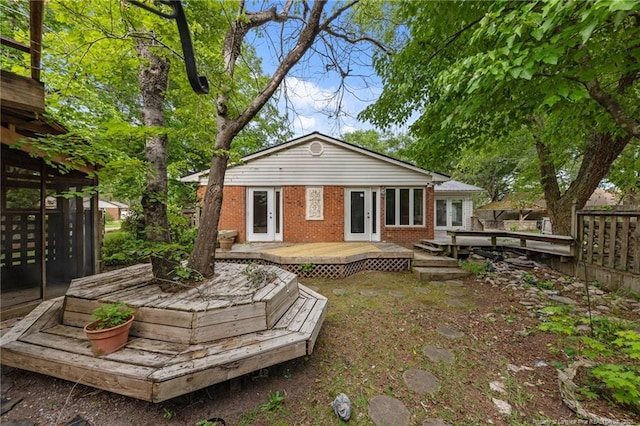 114 Birch Cir, Raeford, NC 28376 - back of property with french doors, a deck, and brick siding