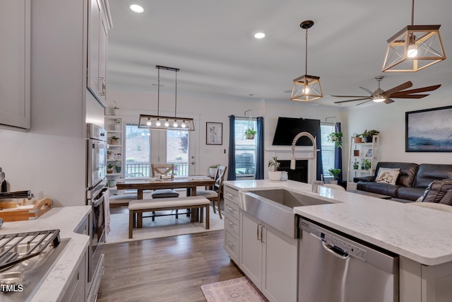 40 Bourne Dr, Franklinton, NC 27525 - kitchen featuring stainless steel appliances, a sink, a ceiling fan, open floor plan, and pendant lighting