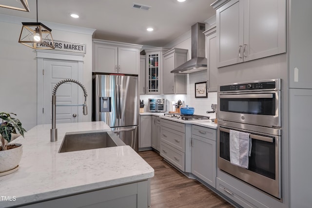 40 Bourne Dr, Franklinton, NC 27525 - kitchen with wall chimney range hood, stainless steel appliances, gray cabinetry, a sink, and backsplash