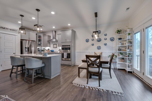 40 Bourne Dr, Franklinton, NC 27525 - kitchen featuring appliances with stainless steel finishes, wall chimney exhaust hood, gray cabinets, ornamental molding, and a center island