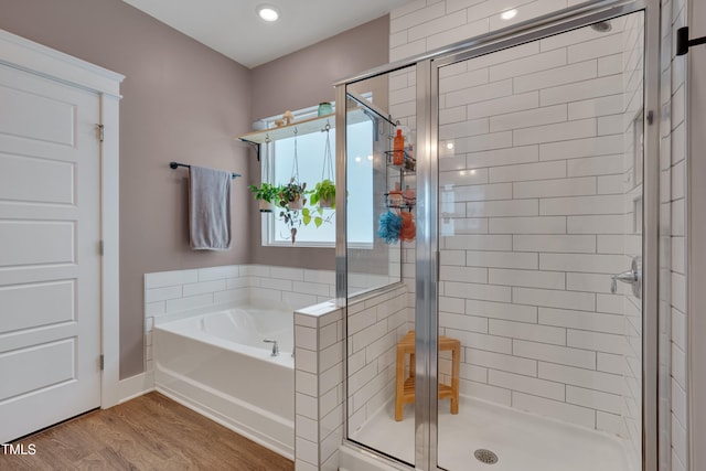 40 Bourne Dr, Franklinton, NC 27525 - bathroom featuring a stall shower, a bath, and wood finished floors