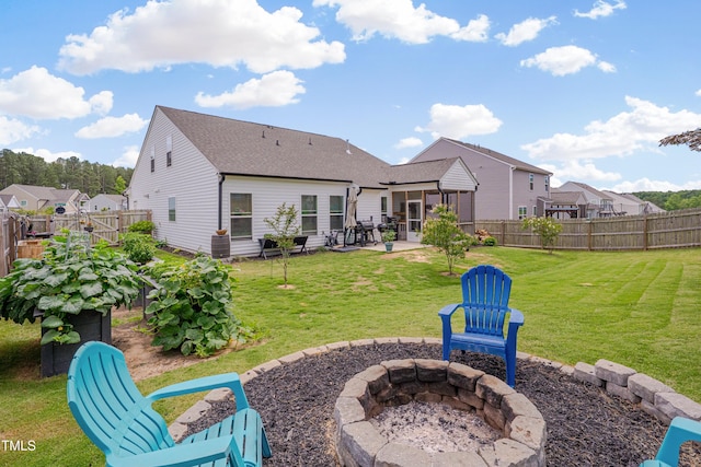 40 Bourne Dr, Franklinton, NC 27525 - rear view of property featuring an outdoor fire pit, a patio area, a sunroom, and a shingled roof