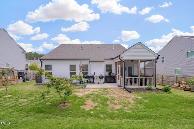 40 Bourne Dr, Franklinton, NC 27525 - back of property featuring a patio area, a sunroom, and roof with shingles