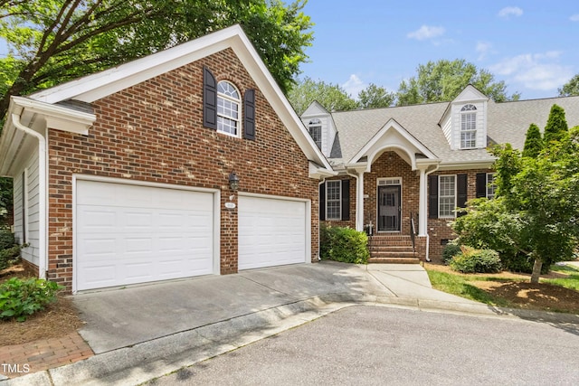 1003 Blackberry Ln, Durham, NC 27712 - view of front of home with driveway, brick siding, a garage, and a shingled roof