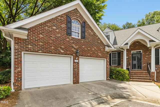 1003 Blackberry Ln, Durham, NC 27712 - view of front of property featuring concrete driveway, brick siding, and a shingled roof