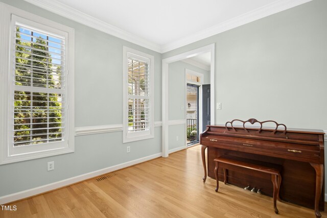 1003 Blackberry Ln, Durham, NC 27712 - living area featuring crown molding and light wood finished floors