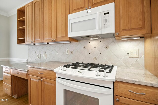 1003 Blackberry Ln, Durham, NC 27712 - kitchen featuring white appliances, open shelves, tasteful backsplash, crown molding, and brown cabinets