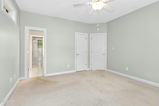 1003 Blackberry Ln, Durham, NC 27712 - unfurnished bedroom with light colored carpet, ensuite bath, and ceiling fan