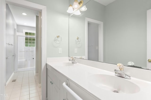 1003 Blackberry Ln, Durham, NC 27712 - bathroom with tile patterned floors, double vanity, a chandelier, and a shower