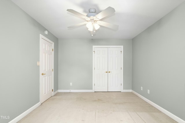 1003 Blackberry Ln, Durham, NC 27712 - unfurnished bedroom with light colored carpet, ceiling fan, and a closet