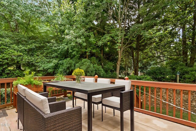 1003 Blackberry Ln, Durham, NC 27712 - deck featuring outdoor dining space and view of scattered trees