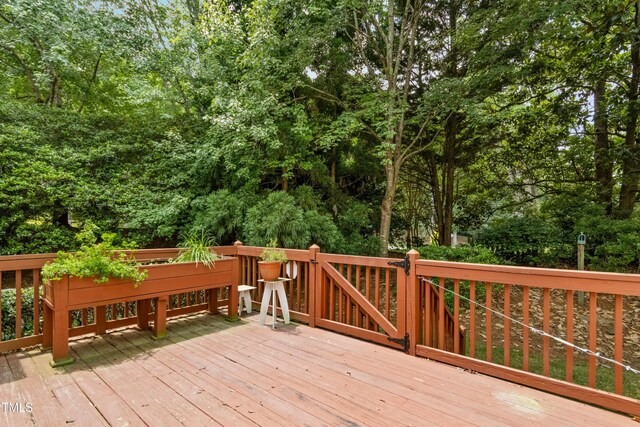 1003 Blackberry Ln, Durham, NC 27712 - wooden deck featuring view of scattered trees