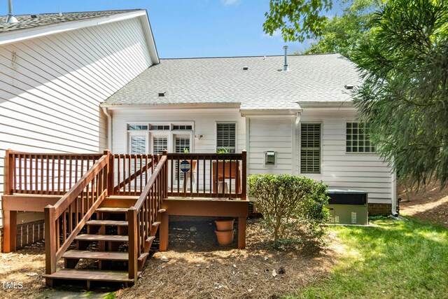 1003 Blackberry Ln, Durham, NC 27712 - back of house featuring a deck, a shingled roof, and stairway