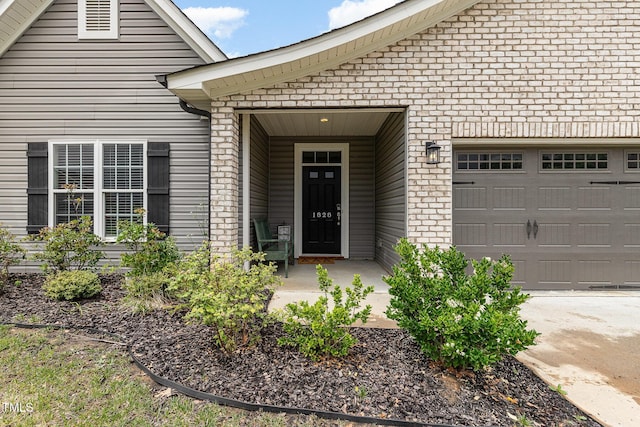1828 Wellspring Ct, Graham, NC 27253 - entrance to property featuring brick siding, a garage, and driveway