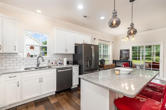 1828 Wellspring Ct, Graham, NC 27253 - kitchen with stainless steel appliances, a sink, dark wood-style floors, decorative backsplash, and crown molding