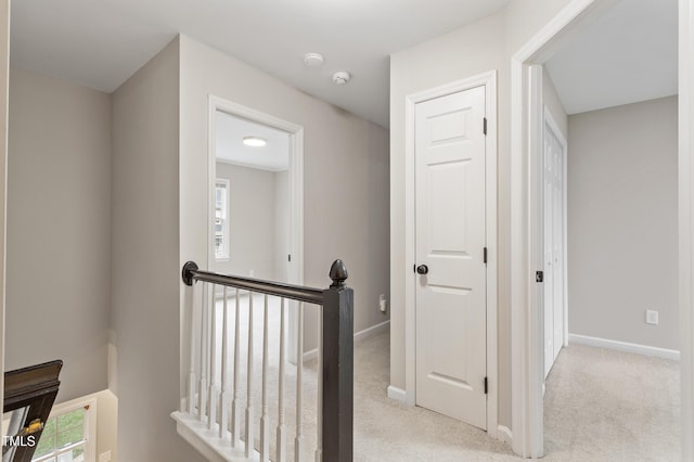 8912 Erinsbrook Dr, Raleigh, NC 27617 - hallway featuring an upstairs landing, carpet flooring, baseboards, and plenty of natural light