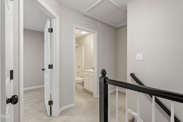 8912 Erinsbrook Dr, Raleigh, NC 27617 - hall with an upstairs landing, attic access, light carpet, and baseboards
