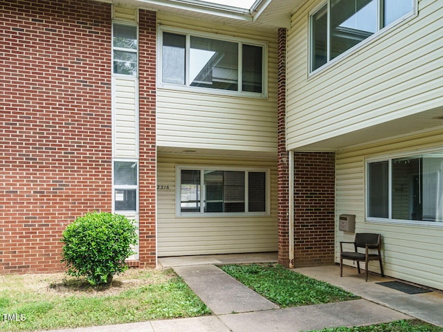 2316 Champion Ct, Raleigh, NC 27606 - view of exterior entry with brick siding and a patio